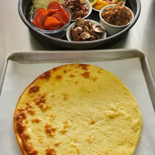 a flat bread and bowls of food