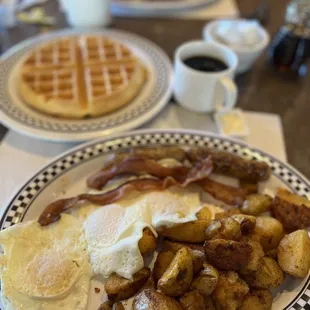 Bacon, sausage, eggs, home potatoes, and a waffle.
