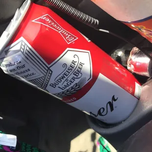 a can of beer in the passenger seat of a car
