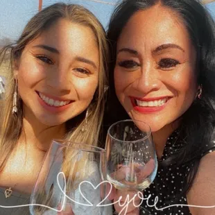 two women holding wine glasses