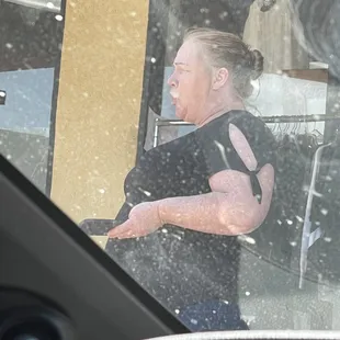 cashier who was on her cellphone and is on it in the photo (: