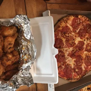 a box of chicken wings and a pepperoni pizza