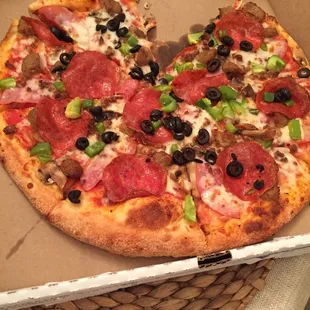 a pepperoni and olive pizza in a box