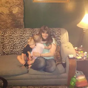 a woman and two children sitting on a couch