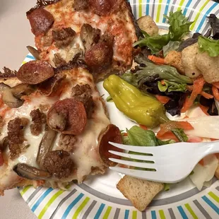 Pepperoni and sausage on vodka sausage and mushrooms with a salad