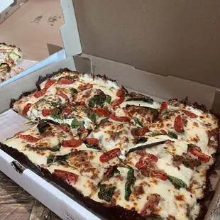 Build your own: Spinach, sausage, cherry tomatoes and white sauce.