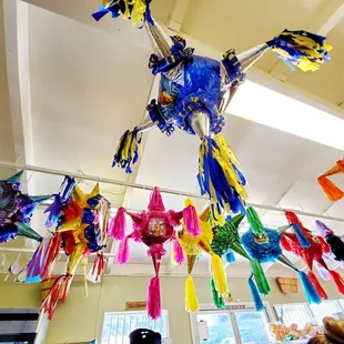a colorful bird hanging from the ceiling