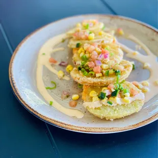 Fried green tomatoes with a pimento cheese underneath