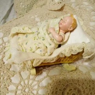 A baby doll in a cradle in good condition
