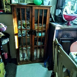 A small shelf with doors that are wood not best condition but I have to or someone needs to give TLC or use drawers for another piece,!