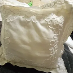 Beautiful white pillow with designs on it both sides