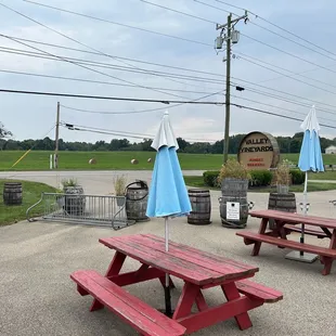 red picnic tables with blue umbrellas
