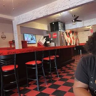 a man sitting at a table in a diner