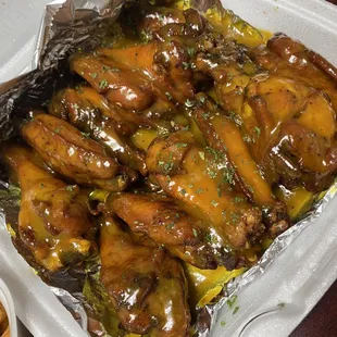 a tray of chicken wings with sauce
