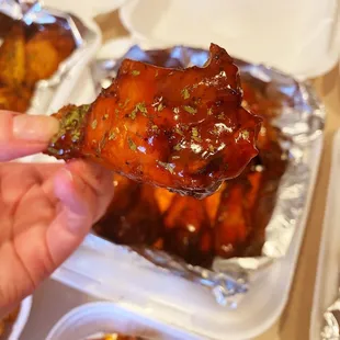 a hand holding a piece of meat