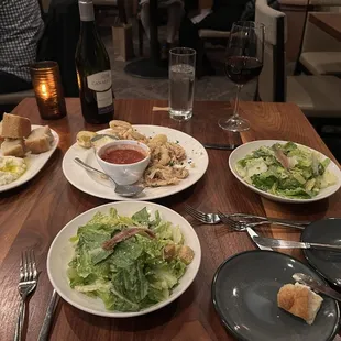 Caesar salad, calamari, bread with ricotta cheese and oil