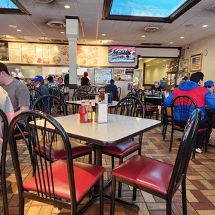 people sitting at tables in a restaurant