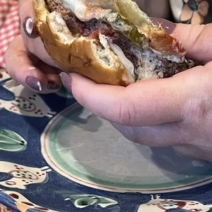 Mama burger with ketchup, mayo, tomato, pickles, and cheddar