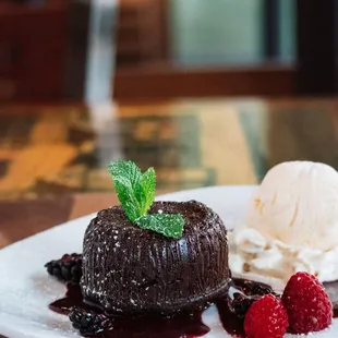 a dessert with ice cream and raspberries