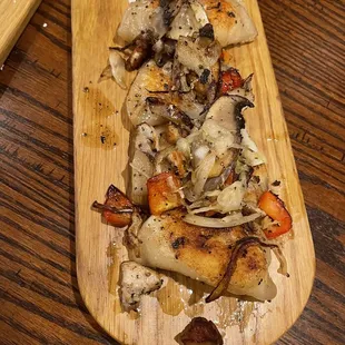 a wooden cutting board with food on it