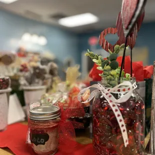 a jar of candy and a candle on a table