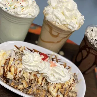 a slice of banana split with whipped cream and sprinkles