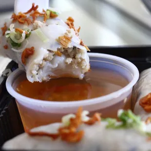 Dipping the banh cuon into the fish sauce..