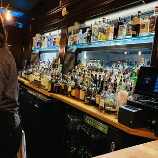 a woman standing at a bar