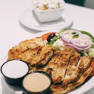 Marinated in house Greek style chicken souvlaki platter served with Greek salad or French fries!