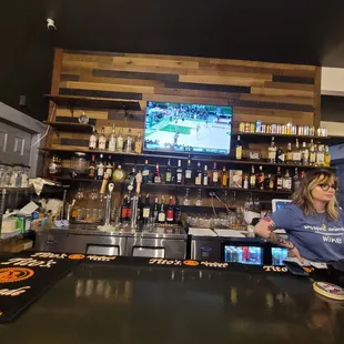 a woman behind the bar