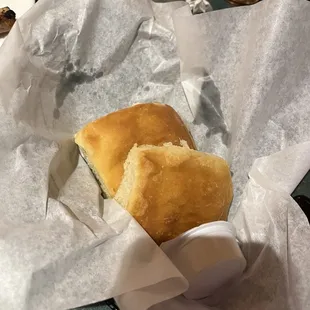 Basket of biscuits with honey butter spread.