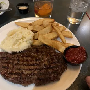 Ribeye with garlic mashed potatoes and steak fries