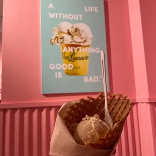 a hand holding a cone of ice cream