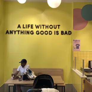 a man sitting at a table in a cafe