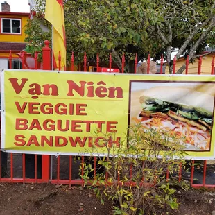 a sign in front of a sandwich shop