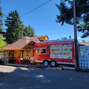 a food truck parked in front of a restaurant