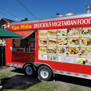 a food truck with a menu on the side