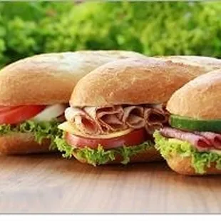 three sandwiches on a table