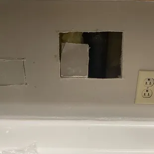 kitchen wall they had to cut out to fix plumbing leak issues and never came back to fix!