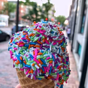 an ice cream cone with sprinkles