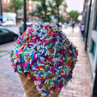 an ice cream cone with sprinkles