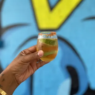 a hand holding a glass of beer