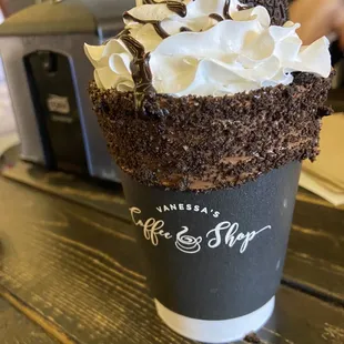 a cup of coffee with whipped cream on top