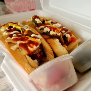 Hot dog with bacon and everything on it.