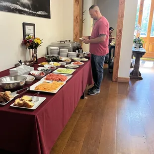 a man standing in front of a buffet table