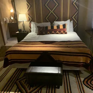 a bedroom with a bed and a bench