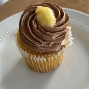 a chocolate frosted cupcake on a white plate