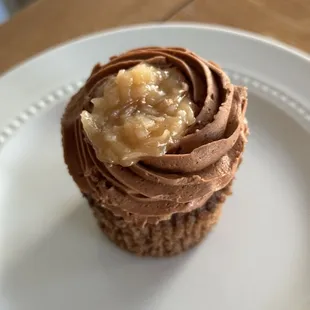 a chocolate cupcake on a white plate