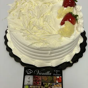a vanilla cake with strawberries on top