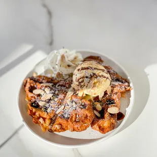 Croffles with ice-cream, whipped cream and almond slices